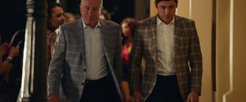 Movie still from “Dirty Grandpa” (2016), directed by Dan Mazer – A couple of men walking down a street holding hands; Medium shot, Over the shoulder angle