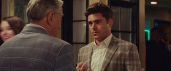 Movie still from “Dirty Grandpa” (2016), directed by Dan Mazer – A man wearing a suit and tie talking to another man; Close Up shot, Over the shoulder angle