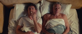 Movie still from “Dirty Grandpa” (2016), directed by Dan Mazer – Two men laying in a bed with white sheets; Medium shot, Overhead angle