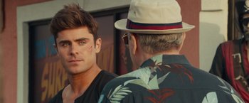 Movie still from “Dirty Grandpa” (2016), directed by Dan Mazer – A man wearing a hat looking into a mirror with another man; Close Up shot, Over the shoulder angle