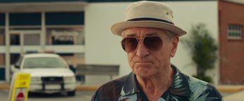 Movie still from “Dirty Grandpa” (2016), directed by Dan Mazer – An older man wearing sunglasses and a hat; Close Up shot, Over the shoulder angle