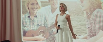 Movie still from “Dirty Grandpa” (2016), directed by Dan Mazer – A woman in a white dress is holding a microphone; Medium shot, Over the shoulder angle