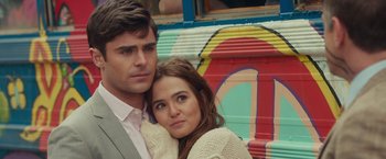 Movie still from “Dirty Grandpa” (2016), directed by Dan Mazer – A man and a woman posing for a picture in front of a bus; Close Up shot, Over the shoulder angle