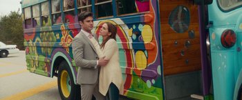 Movie still from “Dirty Grandpa” (2016), directed by Dan Mazer – A man and a woman standing next to each other in front of a bus; Medium shot, Over the shoulder angle