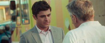 Movie still from “Dirty Grandpa” (2016), directed by Dan Mazer – A man wearing a suit and tie talking to another man wearing a suit and tie; Close Up shot, Over the shoulder angle