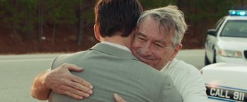 Movie still from “Dirty Grandpa” (2016), directed by Dan Mazer – A man hugging another man in front of a forest; Close Up shot, Over the shoulder angle