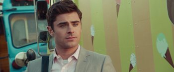 Movie still from “Dirty Grandpa” (2016), directed by Dan Mazer – A man wearing a suit and tie standing in front of a wall; Close Up shot, Over the shoulder angle