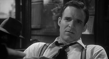 Movie still from “Dead Men Don't Wear Plaid” (1982), directed by Carl Reiner – A black and white photo of a man wearing a tie; Close Up shot, Over the shoulder angle
