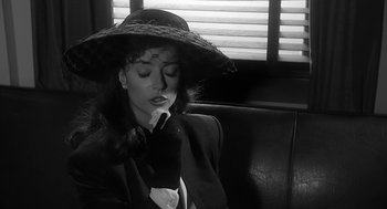 Movie still from “Dead Men Don't Wear Plaid” (1982), directed by Carl Reiner – A black and white photo of a woman wearing a hat; Close Up shot, High angle