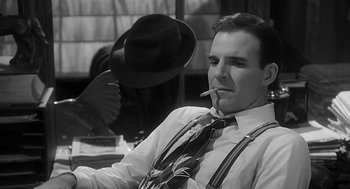 Movie still from “Dead Men Don't Wear Plaid” (1982), directed by Carl Reiner – A black and white photo of a man smoking a cigarette; Close Up shot, Low angle