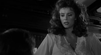 Movie still from “Dead Men Don't Wear Plaid” (1982), directed by Carl Reiner – A black - and - white photo of a woman with long hair; Close Up shot, Over the shoulder angle
