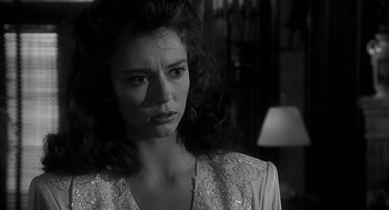 Movie still from “Dead Men Don't Wear Plaid” (1982), directed by Carl Reiner – A black - and - white photo of a woman looking sad; Close Up shot, Over the shoulder angle