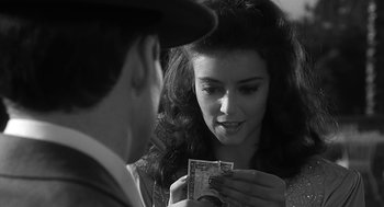 Movie still from “Dead Men Don't Wear Plaid” (1982), directed by Carl Reiner – A man and a woman are looking at each other's bills; Close Up shot, Over the shoulder angle