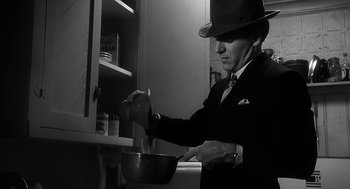 Movie still from “Dead Men Don't Wear Plaid” (1982), directed by Carl Reiner – A man in a suit and hat stirring a pot; Close Up shot, Low angle