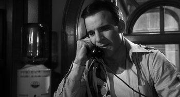Movie still from “Dead Men Don't Wear Plaid” (1982), directed by Carl Reiner – A black and white photo of a man talking on a phone; Close Up shot, Low angle