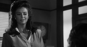 Movie still from “Dead Men Don't Wear Plaid” (1982), directed by Carl Reiner – A black - and - white photo of a woman in a dress shirt; Close Up shot, Over the shoulder angle