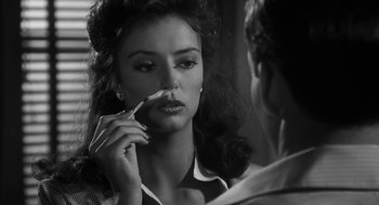 Movie still from “Dead Men Don't Wear Plaid” (1982), directed by Carl Reiner – A black - and - white photo of a woman brushing her teeth in front of a mirror; Close Up shot, Over the shoulder angle