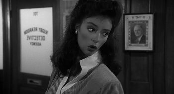 Movie still from “Dead Men Don't Wear Plaid” (1982), directed by Carl Reiner – A black - and - white photo of a woman in a dress; Close Up shot, Over the shoulder angle