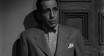 Movie still from “Dead Men Don't Wear Plaid” (1982), directed by Carl Reiner – A man wearing a suit and bow tie; Close Up shot, High angle