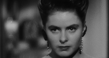 Movie still from “Dead Men Don't Wear Plaid” (1982), directed by Carl Reiner – A black and white photo of a woman with big earrings; Close Up shot, Low angle