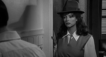 Movie still from “Dead Men Don't Wear Plaid” (1982), directed by Carl Reiner – A black and white photo of a woman wearing a hat; Close Up shot, Over the shoulder angle