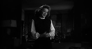 Movie still from “Dead Men Don't Wear Plaid” (1982), directed by Carl Reiner – A black and white photo of a woman in a room; Medium shot, Low angle