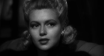 Movie still from “Dead Men Don't Wear Plaid” (1982), directed by Carl Reiner – A black and white photo of a woman with big hair; Close Up shot, Low angle