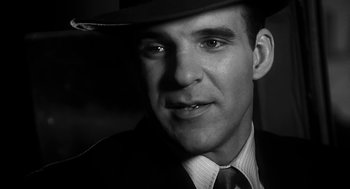 Movie still from “Dead Men Don't Wear Plaid” (1982), directed by Carl Reiner – A black and white photo of a man wearing a hat; Close Up shot, Low angle