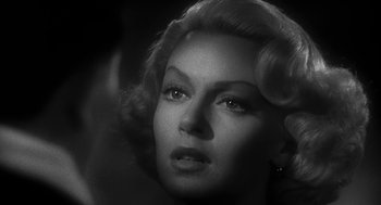 Movie still from “Dead Men Don't Wear Plaid” (1982), directed by Carl Reiner – A black and white photo of a woman with a hair piece; Close Up shot, Over the shoulder angle