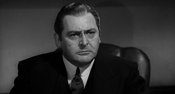 Movie still from “Dead Men Don't Wear Plaid” (1982), directed by Carl Reiner – An older man in a suit and tie; Close Up shot, Low angle