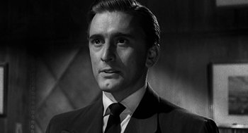 Movie still from “Dead Men Don't Wear Plaid” (1982), directed by Carl Reiner – Black and white photograph of a man wearing a suit and tie; Close Up shot, Low angle