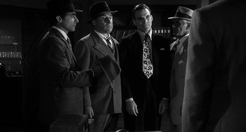 Movie still from “Dead Men Don't Wear Plaid” (1982), directed by Carl Reiner – A black and white photo of a group of men in suits and ties; Medium shot, Over the shoulder angle