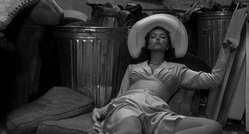 Movie still from “Dead Men Don't Wear Plaid” (1982), directed by Carl Reiner – A black and white photo of a woman wearing a hat; Medium shot, High angle