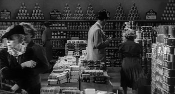 Movie still from “Dead Men Don't Wear Plaid” (1982), directed by Carl Reiner – A black and white photo of people shopping in a store; Wide shot, High angle
