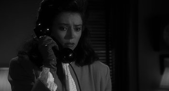 Movie still from “Dead Men Don't Wear Plaid” (1982), directed by Carl Reiner – A black and white photo of a woman talking on a phone; Close Up shot, High angle