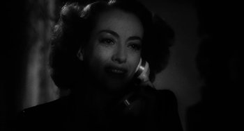 Movie still from “Dead Men Don't Wear Plaid” (1982), directed by Carl Reiner – A woman talking on a phone in a black and white photo; Close Up shot, High angle