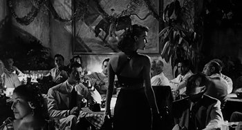 Movie still from “Dead Men Don't Wear Plaid” (1982), directed by Carl Reiner – A black and white photo of a woman in a dress; Wide shot, Low angle