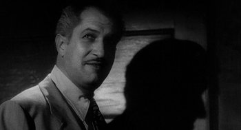 Movie still from “Dead Men Don't Wear Plaid” (1982), directed by Carl Reiner – A black and white photo of a man in a suit and tie; Close Up shot, Low angle