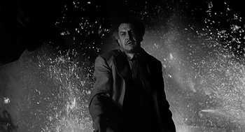 Movie still from “Dead Men Don't Wear Plaid” (1982), directed by Carl Reiner – A black and white photo of a man in a suit; Medium shot, Low angle