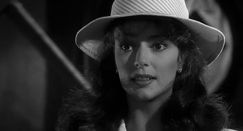 Movie still from “Dead Men Don't Wear Plaid” (1982), directed by Carl Reiner – A black and white photo of a woman wearing a hat; Close Up shot, Over the shoulder angle