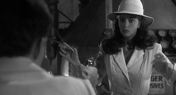 Movie still from “Dead Men Don't Wear Plaid” (1982), directed by Carl Reiner – A black - and - white photo of a woman wearing a hat; Close Up shot, Over the shoulder angle