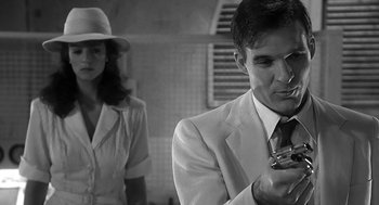 Movie still from “Dead Men Don't Wear Plaid” (1982), directed by Carl Reiner – A man in a white suit and a woman in a white hat; Close Up shot, Over the shoulder angle