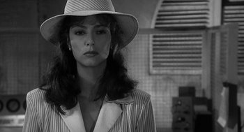 Movie still from “Dead Men Don't Wear Plaid” (1982), directed by Carl Reiner – A black and white photo of a woman wearing a hat; Close Up shot, Over the shoulder angle