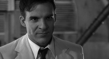 Movie still from “Dead Men Don't Wear Plaid” (1982), directed by Carl Reiner – Black and white photograph of a man wearing a suit and tie; Close Up shot, Over the shoulder angle