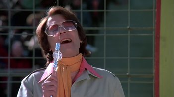Movie still from “Death Race 2000” (1975), directed by Paul Bartel – A woman holding a toothbrush in her mouth; Close Up shot, Low angle
