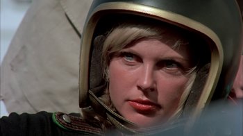Movie still from “Death Race 2000” (1975), directed by Paul Bartel – A person wearing a space helmet; Close Up shot, Low angle
