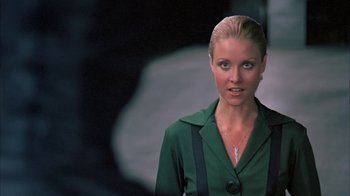 Movie still from “Death Race 2000” (1975), directed by Paul Bartel – A beautiful blonde woman in a green shirt; Close Up shot, Over the shoulder angle