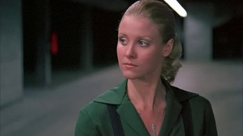 Movie still from “Death Race 2000” (1975), directed by Paul Bartel – A woman in a green shirt looking to her left; Close Up shot, Low angle