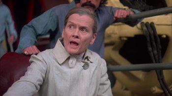 Movie still from “Death Race 2000” (1975), directed by Paul Bartel – A man with a surprised look on his face; Close Up shot, Low angle