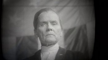 Movie still from “Death Race 2000” (1975), directed by Paul Bartel – An old photo of an old man in a suit; Close Up shot, Low angle